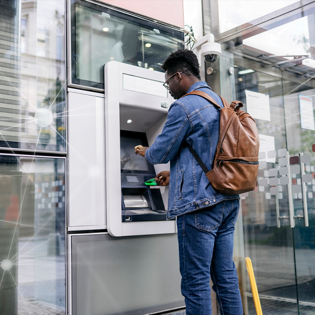 A Man Trying to Use an ATM