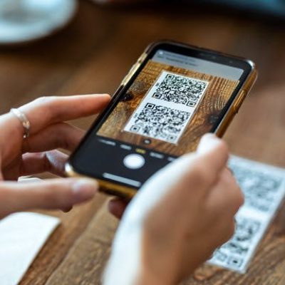 Person scanning QR code on mobile phone.
