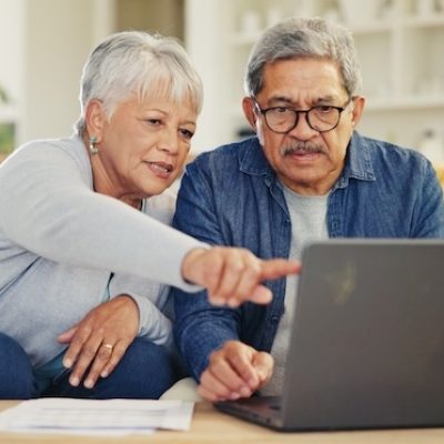senior couple looking at their laptop